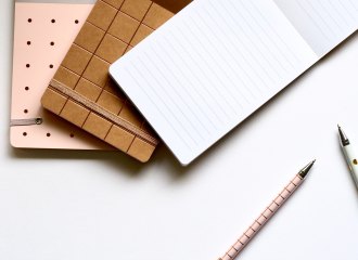 Three notebooks and a pen