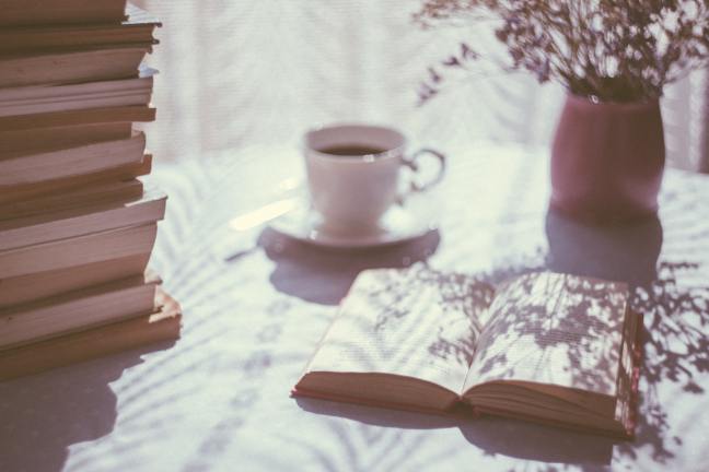 Book on table with coffee cup