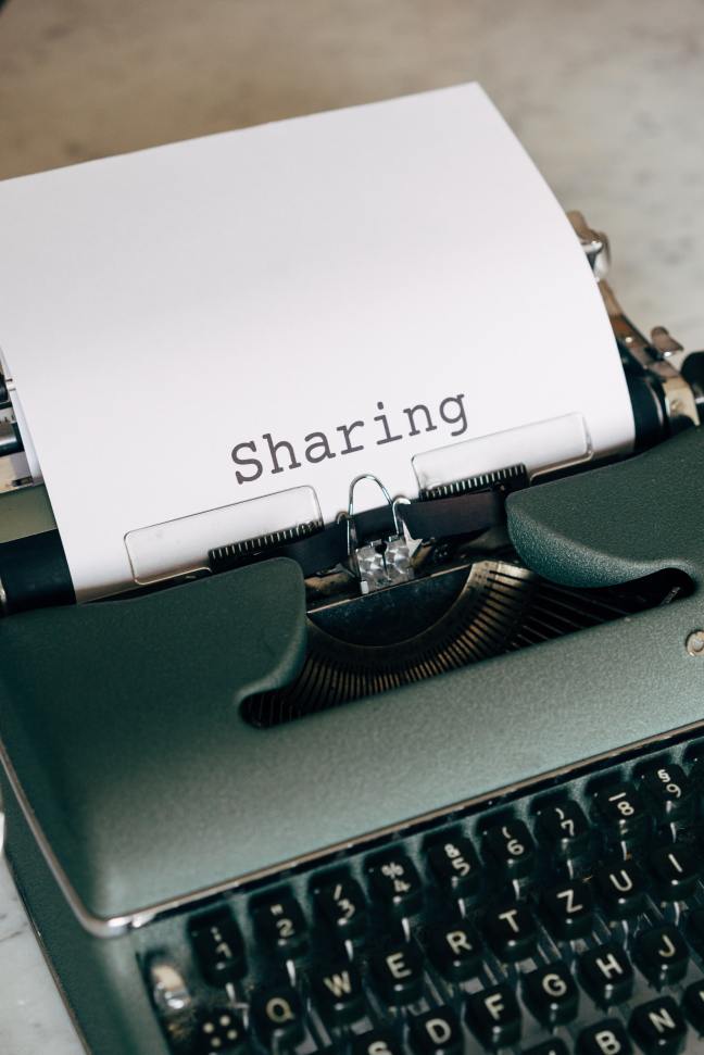 Typewriter with the word 'sharing' on the inserted paper